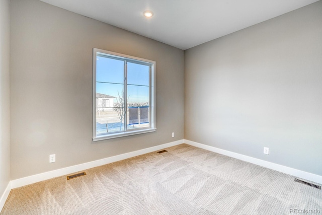 empty room featuring light colored carpet