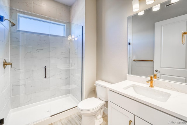 bathroom featuring toilet, an enclosed shower, and vanity