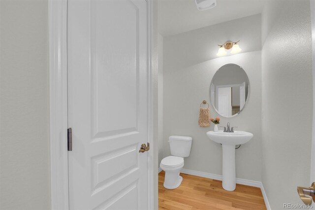 5887 S Taft Ln, Littleton, CO 80127 - bathroom with toilet and wood finished floors