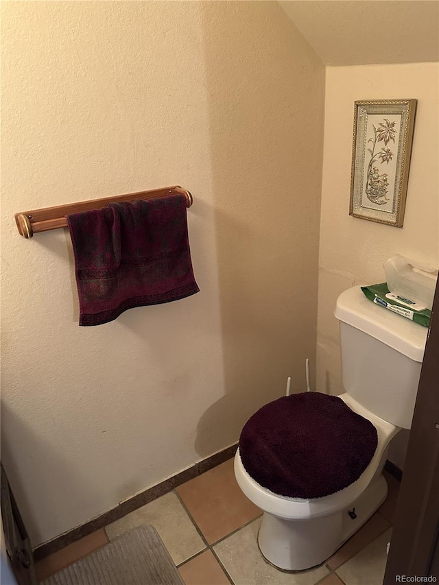 bathroom with toilet and tile patterned floors