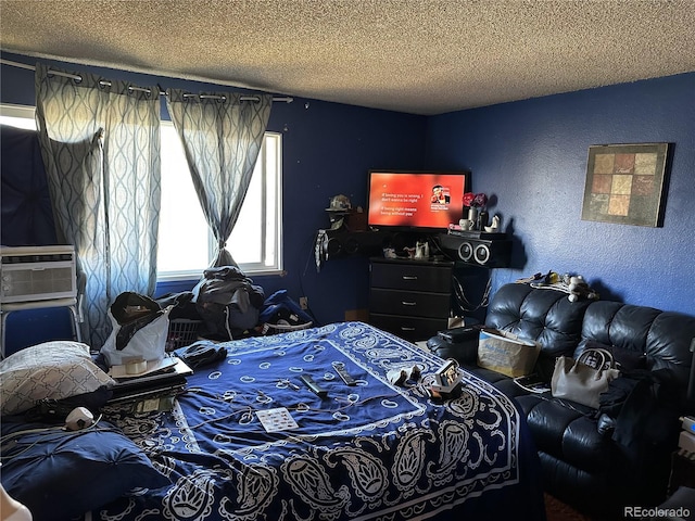 bedroom featuring a textured ceiling and cooling unit