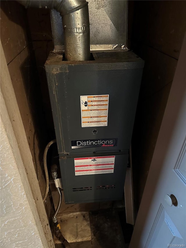 utility room featuring heating unit