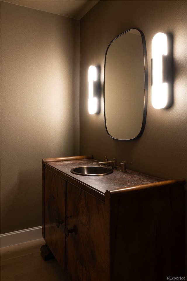 bathroom with vanity and wood-type flooring