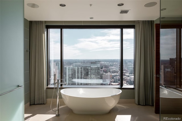 bathroom with tile patterned floors and a bathtub