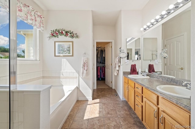12522 Locust Way, Thornton, CO 80602 - full bath with double vanity, a garden tub, and a walk in closet