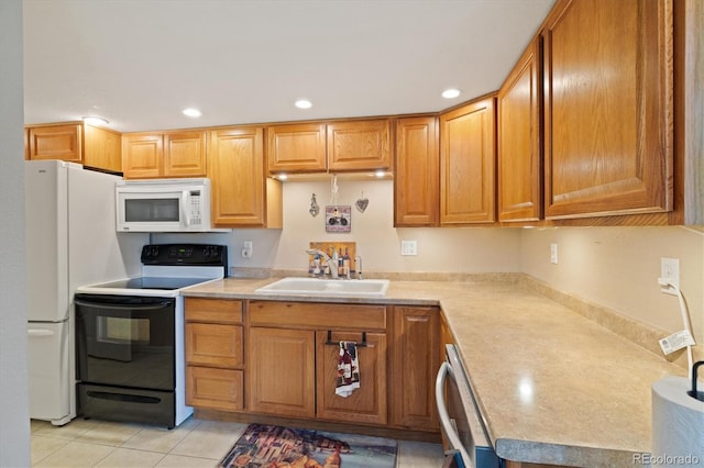 12522 Locust Way, Thornton, CO 80602 - kitchen with white appliances, light countertops, recessed lighting, light tile patterned floors, and brown cabinetry