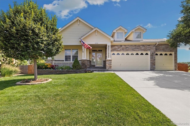12522 Locust Way, Thornton, CO 80602 - craftsman house featuring an attached garage, driveway, stone siding, and a porch