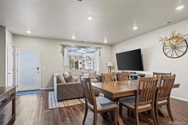 dining space with visible vents, a textured ceiling, wood finished floors, recessed lighting, and baseboards