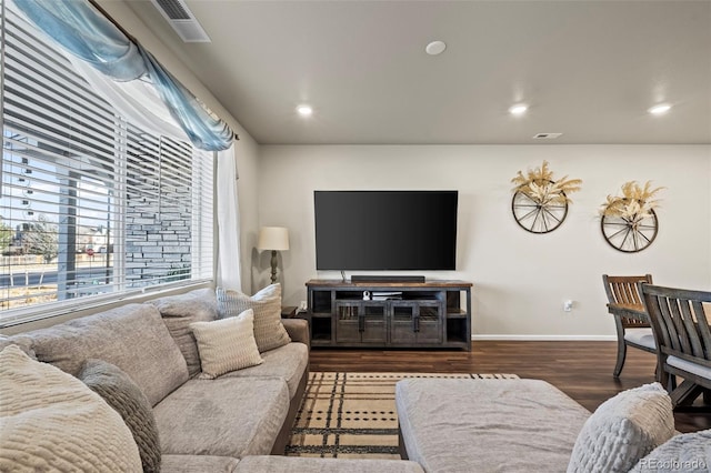 living room with recessed lighting, wood finished floors, visible vents, and baseboards