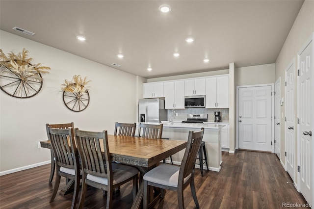 dining area featuring visible vents, recessed lighting, dark wood-type flooring, and baseboards