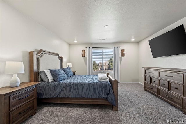 carpeted bedroom featuring visible vents, baseboards, and a textured ceiling