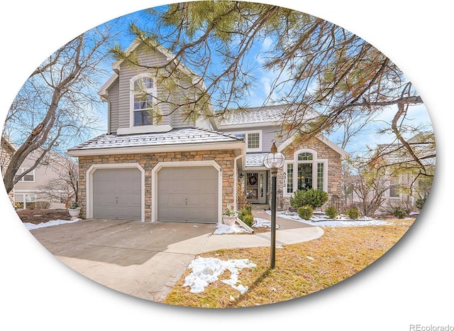 view of front of property featuring driveway, stone siding, and an attached garage