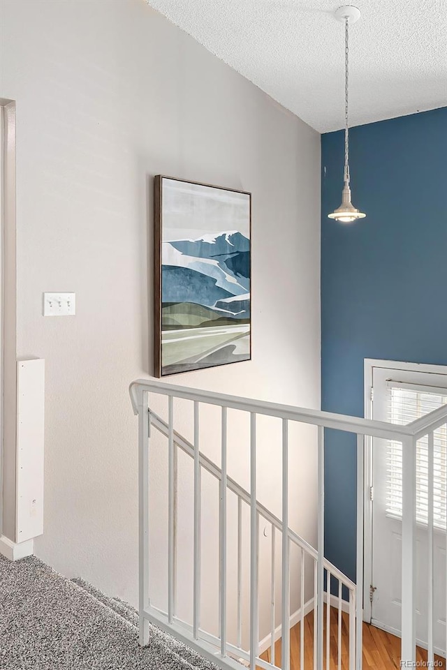 hallway with a textured ceiling