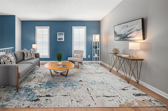 living area featuring baseboards and wood finished floors