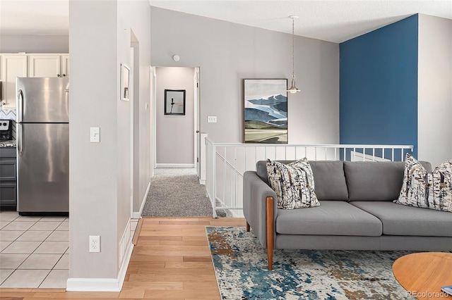 living room with baseboards and light wood-style floors