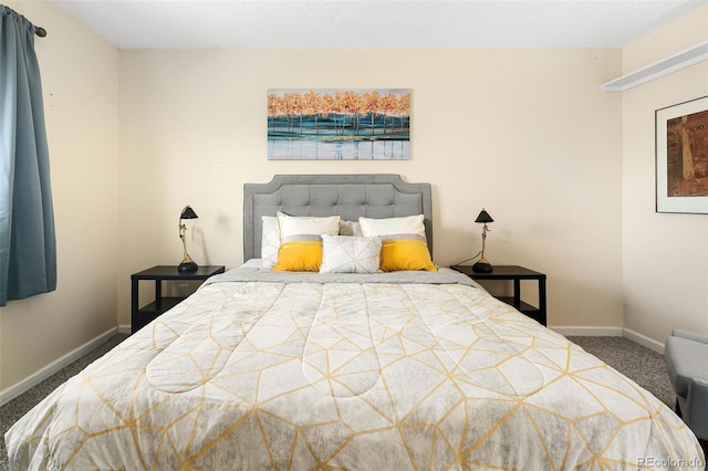 bedroom featuring carpet and baseboards