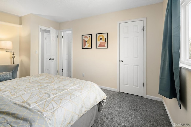 bedroom featuring baseboards and dark colored carpet