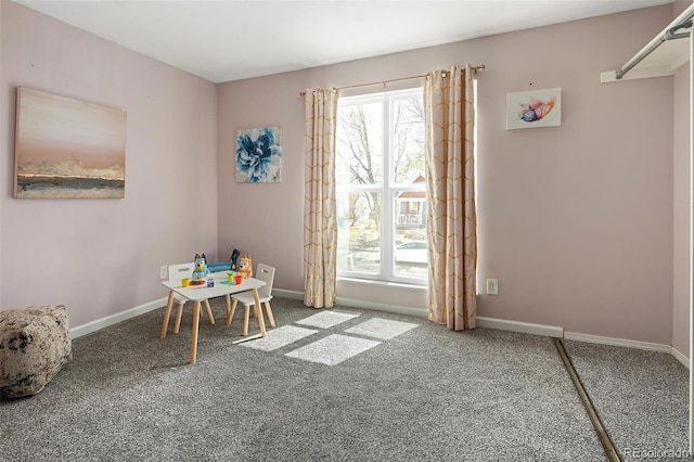 rec room featuring carpet floors and baseboards