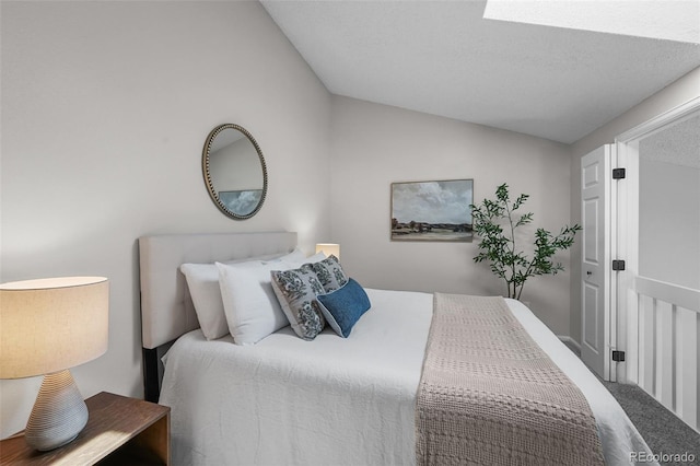bedroom with lofted ceiling and carpet