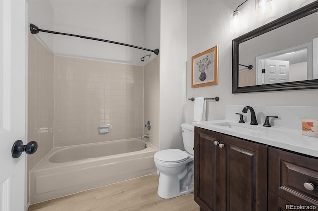 full bathroom featuring wood finished floors, toilet,  shower combination, and vanity
