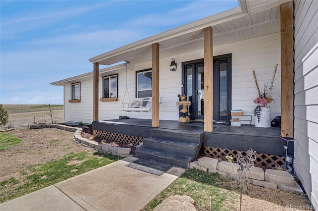 entrance to property featuring a porch
