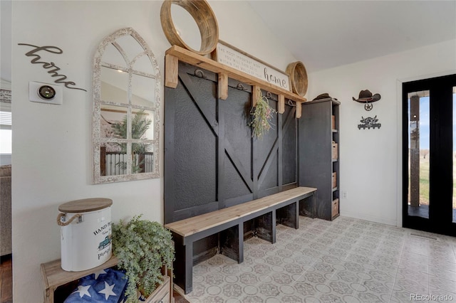 mudroom with lofted ceiling and a healthy amount of sunlight