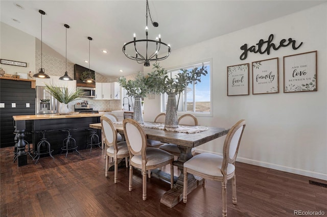 dining room featuring recessed lighting, lofted ceiling, an inviting chandelier, visible vents, and dark wood-type flooring