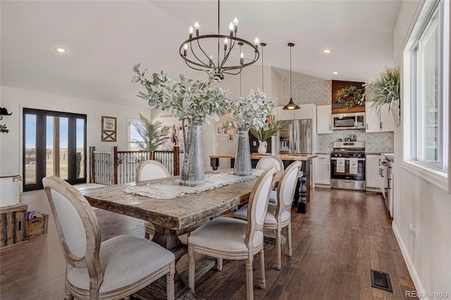 dining space featuring dark wood finished floors, an inviting chandelier, visible vents, and recessed lighting