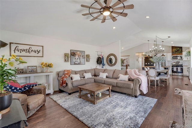 living area featuring recessed lighting, lofted ceiling, dark wood-type flooring, and ceiling fan with notable chandelier