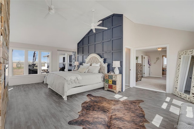 bedroom with baseboards, wood finished floors, a ceiling fan, and high vaulted ceiling