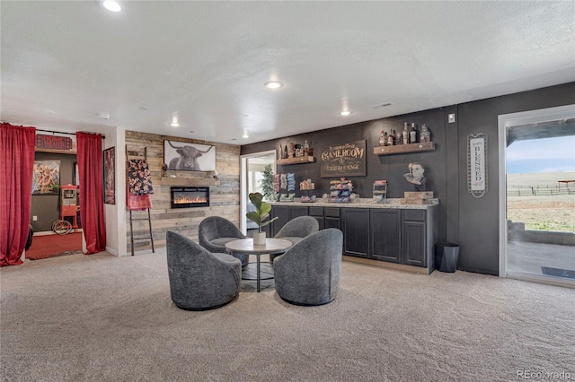 dining space with light colored carpet, a dry bar, a stone fireplace, and visible vents