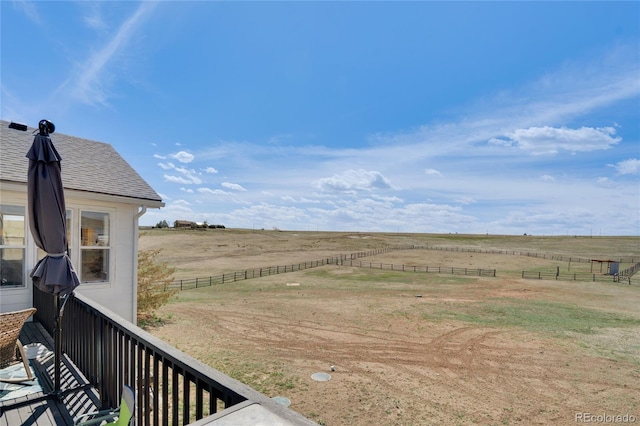 view of yard featuring a rural view and fence