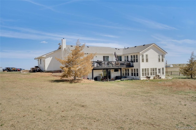 back of house featuring a chimney and a wooden deck