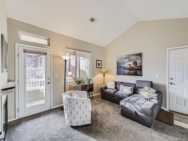 living room featuring lofted ceiling, baseboards, visible vents, and carpet