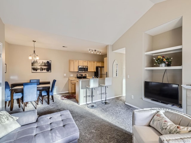 carpeted living area with vaulted ceiling, built in shelves, a notable chandelier, and baseboards