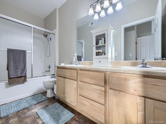 full bathroom with shower / bath combination with glass door, double vanity, visible vents, toilet, and a sink