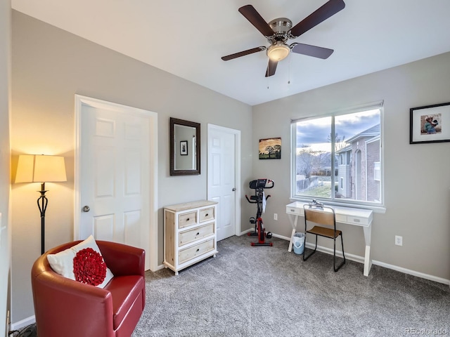 living area with carpet floors, a ceiling fan, and baseboards