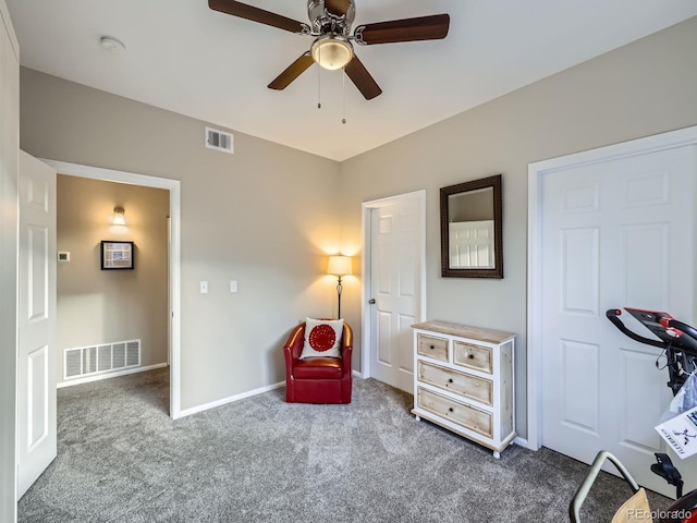 sitting room with a ceiling fan, carpet, visible vents, and baseboards