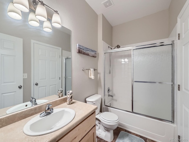 bathroom featuring visible vents, toilet, combined bath / shower with glass door, vanity, and a chandelier