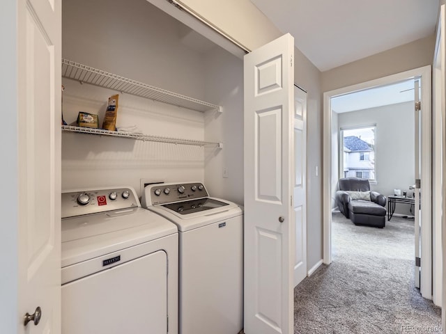 clothes washing area with laundry area, separate washer and dryer, and carpet flooring