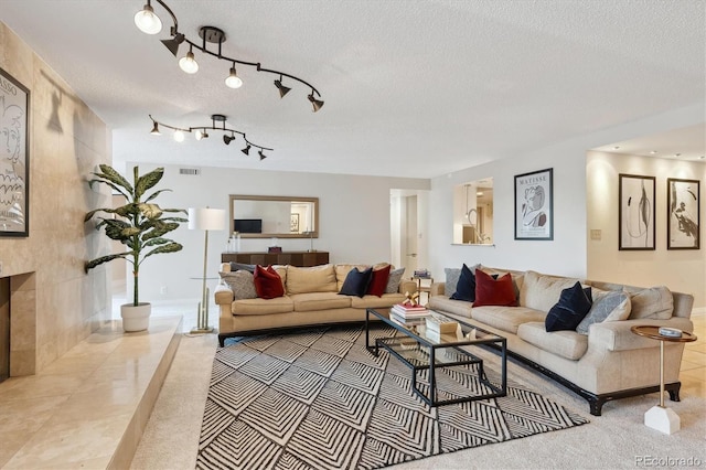 living room with a fireplace and a textured ceiling