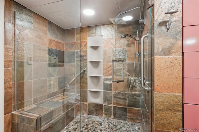 bathroom with a shower with shower door