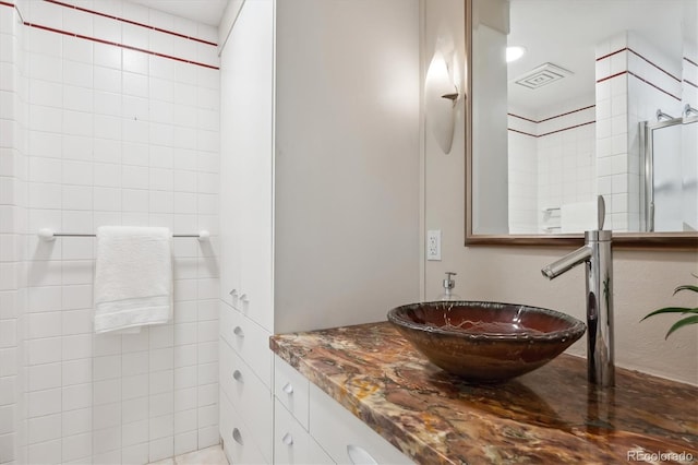 bathroom with sink and an enclosed shower