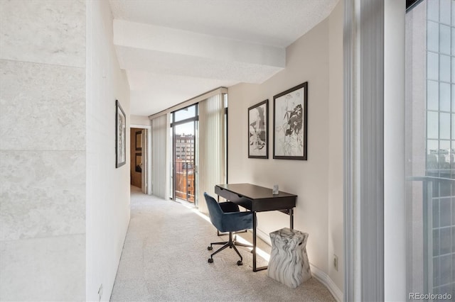 carpeted home office with a textured ceiling