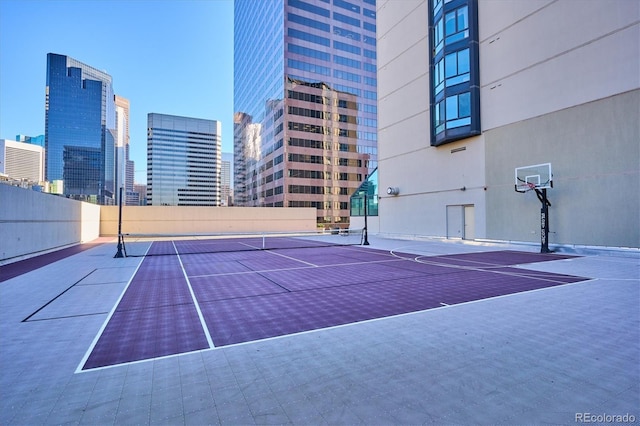 view of tennis court with basketball hoop