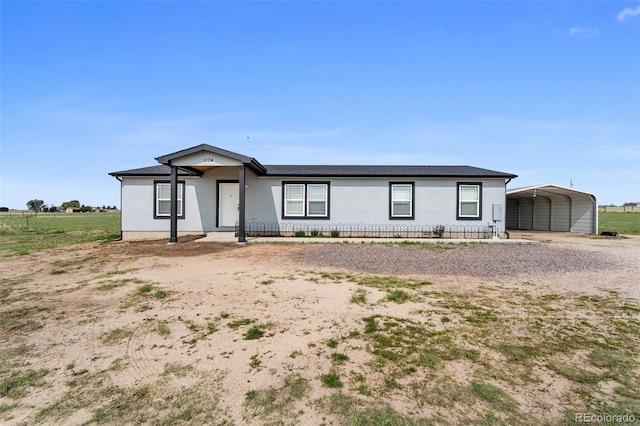 1134 Buffalo Run Rd, Calhan, CO 80808 - view of front facade featuring a carport, stucco siding, and driveway