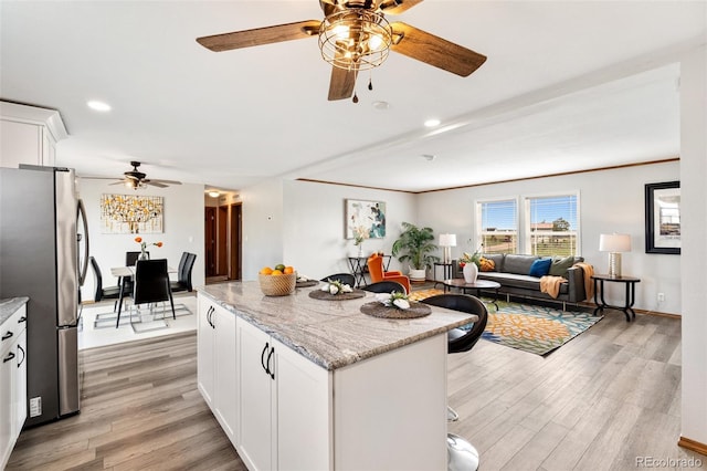 1134 Buffalo Run Rd, Calhan, CO 80808 - kitchen featuring freestanding refrigerator, ceiling fan, light wood finished floors, open floor plan, and recessed lighting