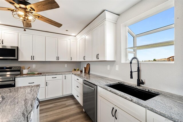 1134 Buffalo Run Rd, Calhan, CO 80808 - kitchen featuring stainless steel appliances, a sink, white cabinetry, and light wood-style floors