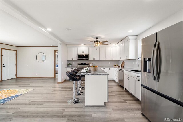 1134 Buffalo Run Rd, Calhan, CO 80808 - kitchen featuring appliances with stainless steel finishes, recessed lighting, ceiling fan, a kitchen island, and white cabinets