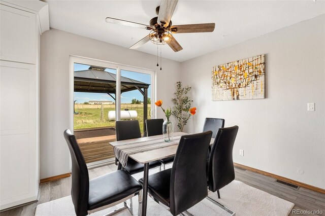 1134 Buffalo Run Rd, Calhan, CO 80808 - dining room featuring ceiling fan, baseboards, and wood finished floors